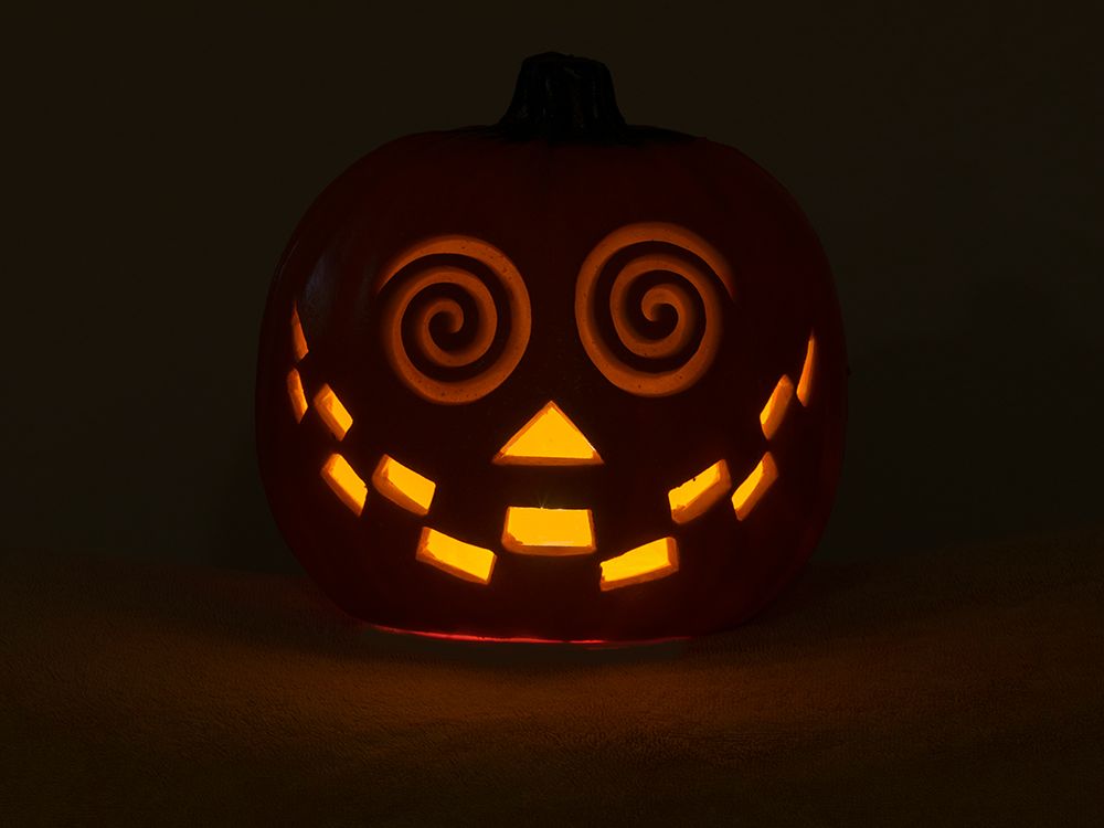 USA-Washington State Smiling Jack O Lantern face on Pumpkin at Halloween-at night